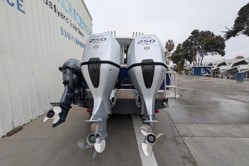 Slide: The Image of 2022 Hewscraft Pacific Explorer with dual Honda 250 VTEC outboard motors at a boatyard. - 10