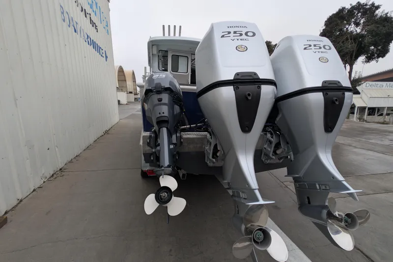 Slide: The Image of 2022 Hewscraft Pacific Explorer with triple Honda 250 VTEC outboard engines. - 11