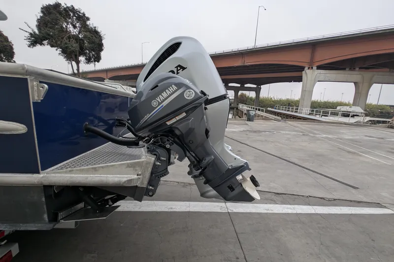 Slide: The Image of 2022 Hewscraft Pacific Explorer with Yamaha outboard motor at a dockside location. - 12