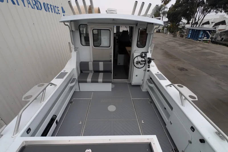 Slide: The Image of 2022 Hewscraft Pacific Explorer boat interior with seating and steering wheel. - 14