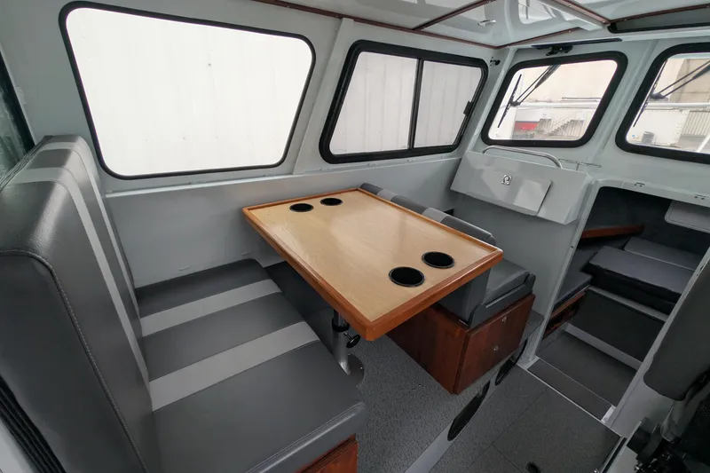 Slide: The Image of Interior of 2022 Hewscraft Pacific Explorer boat with seating and table. - 26