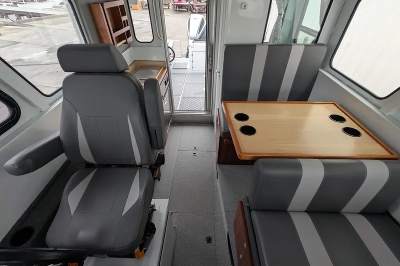 Slide: The Image of 2022 Hewscraft Pacific Explorer interior with seating and table setup. - 33