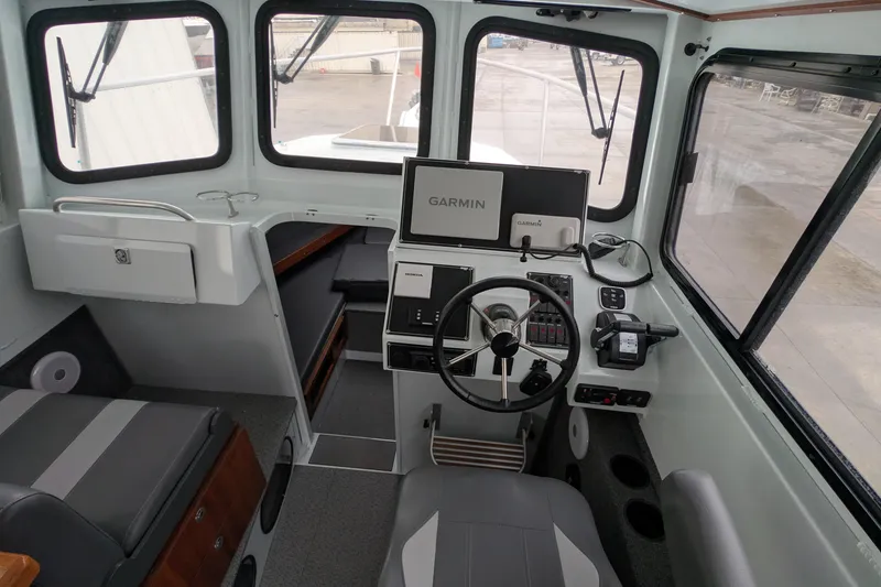 Slide: The Image of 2022 Hewscraft Pacific Explorer boat interior with Garmin navigation system and modern controls. - 34