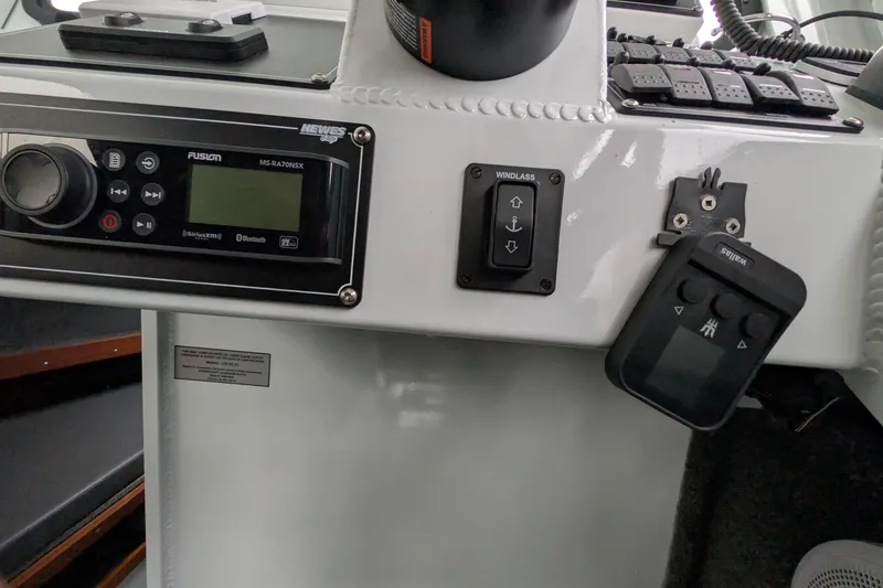Slide: The Image of Control panel of 2022 Hewscraft Pacific Explorer boat with audio system and windlass controls. - 38