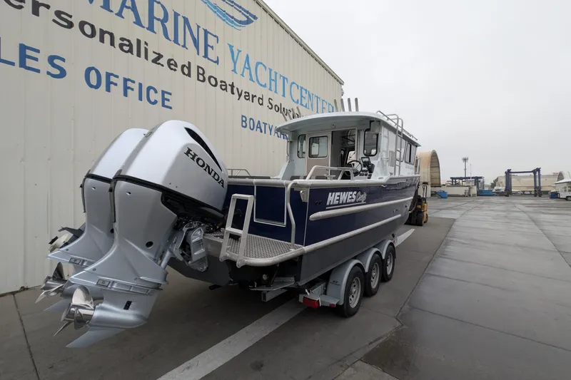 Slide: The Image of 2022 Hewscraft Pacific Explorer boat with Honda engines at a marine yacht center. - 4