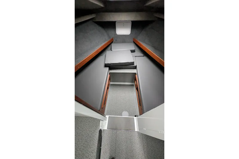Slide: The Image of 2022 Hewscraft Pacific Explorer cabin interior with gray cushions and wooden accents. - 43