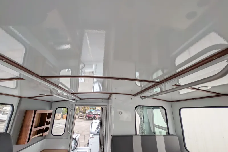 Slide: The Image of Interior of 2022 Hewscraft Pacific Explorer boat, featuring sleek design and ample windows. - 46