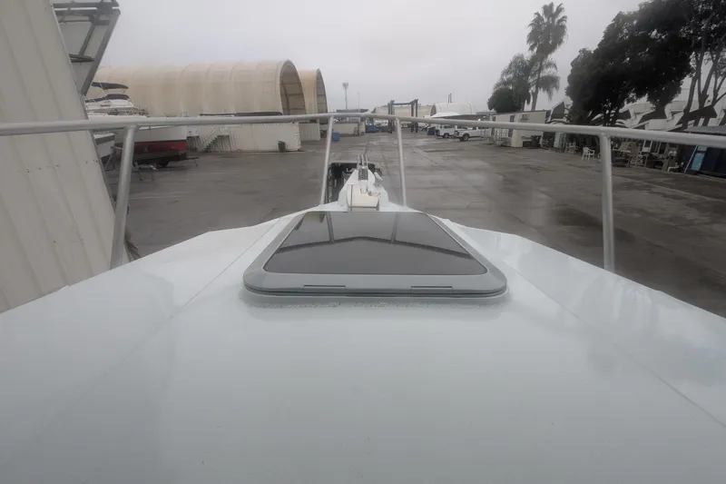Slide: The Image of 2022 Hewscraft Pacific Explorer boat on a dock, overcast day, industrial background. - 51