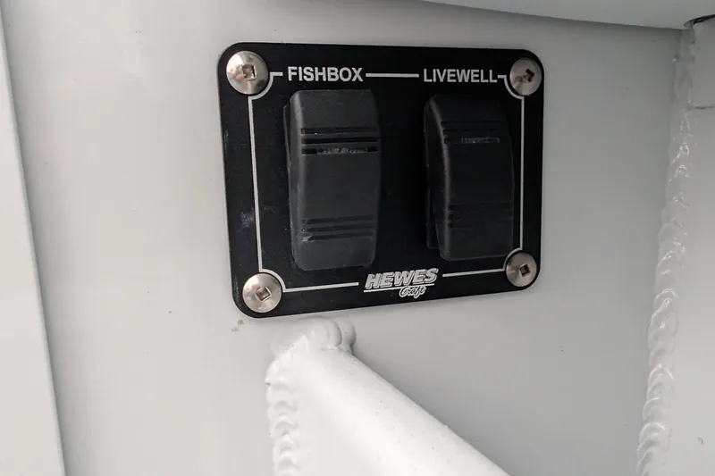 Slide: The Image of Control panel on 2022 Hewscraft Pacific Explorer, featuring fishbox and livewell switches. - 53