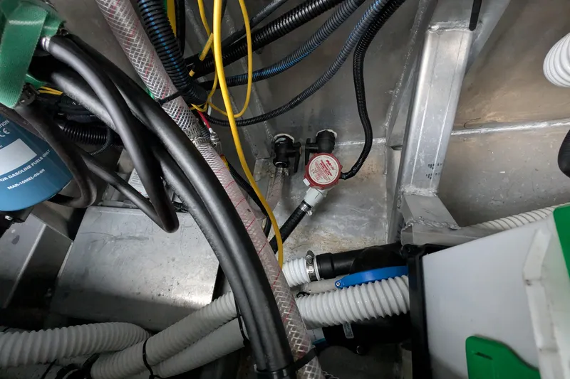 Slide: The Image of Engine compartment of 2022 Hewscraft Pacific Explorer with cables and hoses. - 57
