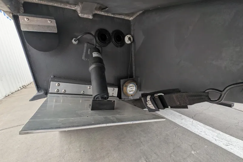 Slide: The Image of 2022 Hewscraft Pacific Explorer boat underside showing trim tab and hydraulic components. - 59