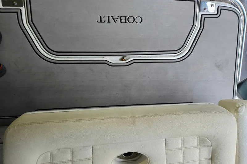Slide: The Image of Cobalt R7 Surf 2020 boat interior with beige seating and branded flooring. - 14