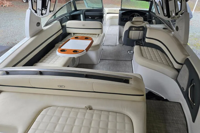 Slide: The Image of 2020 Cobalt R7 Surf boat interior with luxurious seating and table setup. - 16