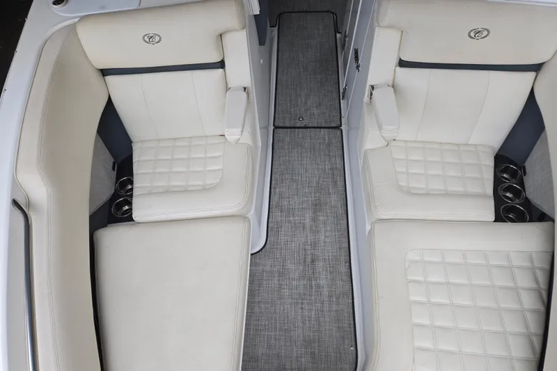 Slide: The Image of 2020 Cobalt R7 Surf boat interior with white cushioned seating and cup holders. - 23