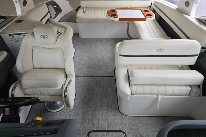 Slide: The Image of Interior of a 2020 Cobalt R7 Surf boat with luxurious white seating and table. - 24