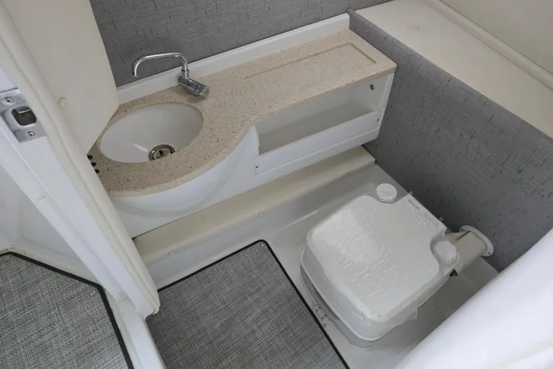 Slide: The Image of 2020 Cobalt R7 Surf boat bathroom with sink and toilet, featuring modern design. - 27