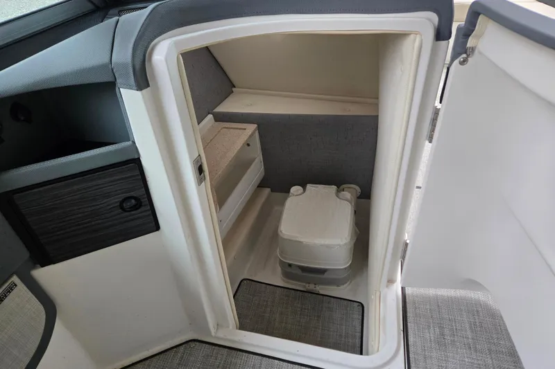 Slide: The Image of 2020 Cobalt R7 Surf boat interior with compact storage and portable toilet. - 28