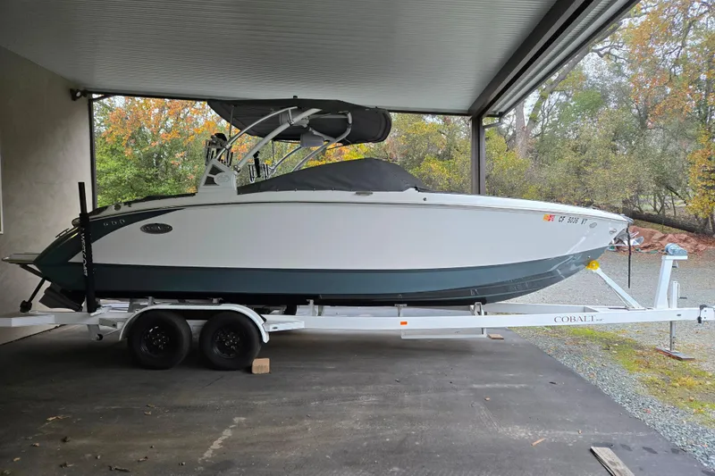 Slide: The Image of 2020 Cobalt R7 Surf boat on trailer under shelter, side view. - 30