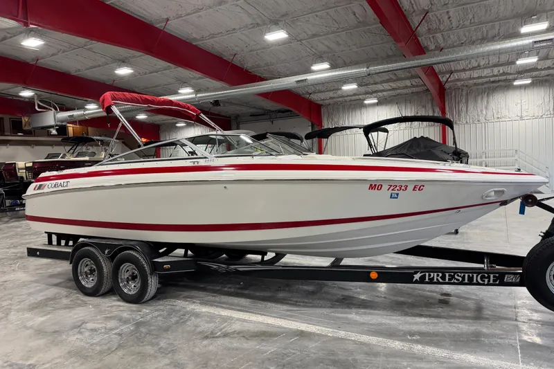 Slide: The Image of 1995 Cobalt 252 boat on trailer in indoor storage facility. - 12