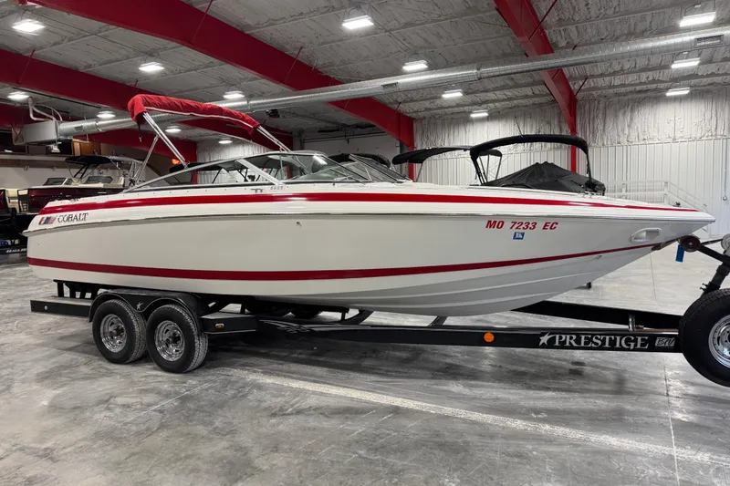 Slide: The Image of 1995 Cobalt 252 boat on trailer in indoor storage facility. - 16