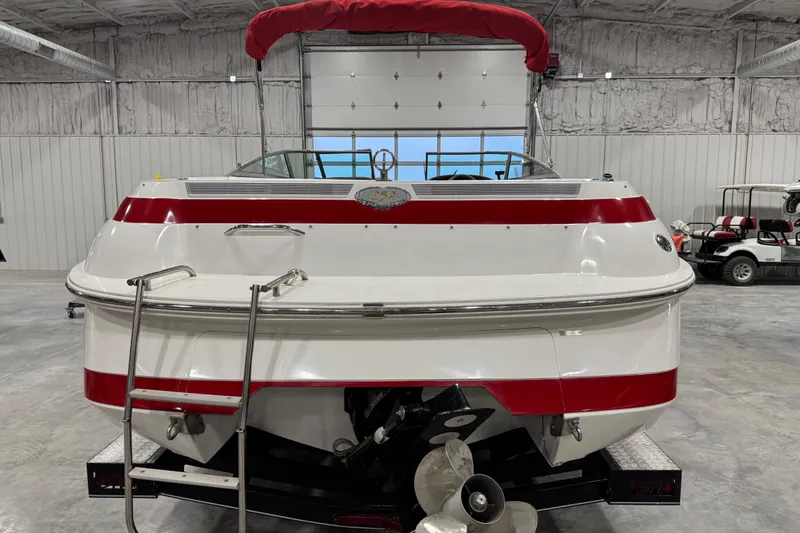 Slide: The Image of 1995 Cobalt 252 boat with red accents in a garage setting. - 18