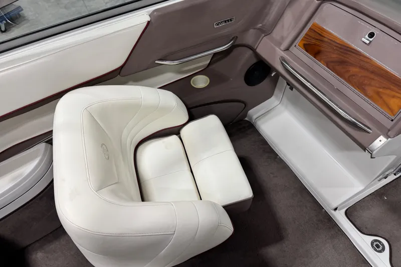 Slide: The Image of Interior of a 1995 Cobalt 252 boat with white seating and wood accents. - 23