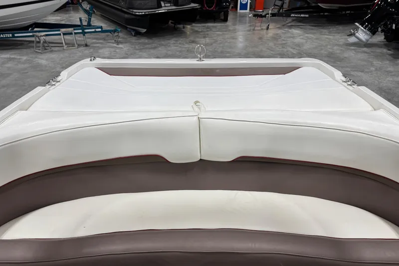 Slide: The Image of Interior seating of a 1995 Cobalt 252 boat, featuring white and brown upholstery. - 25