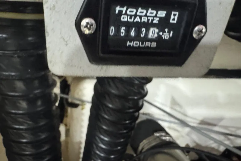 Slide: The Image of Hobbs Quartz hour meter reading 543.9 hours on a 1995 Cobalt 252. - 28