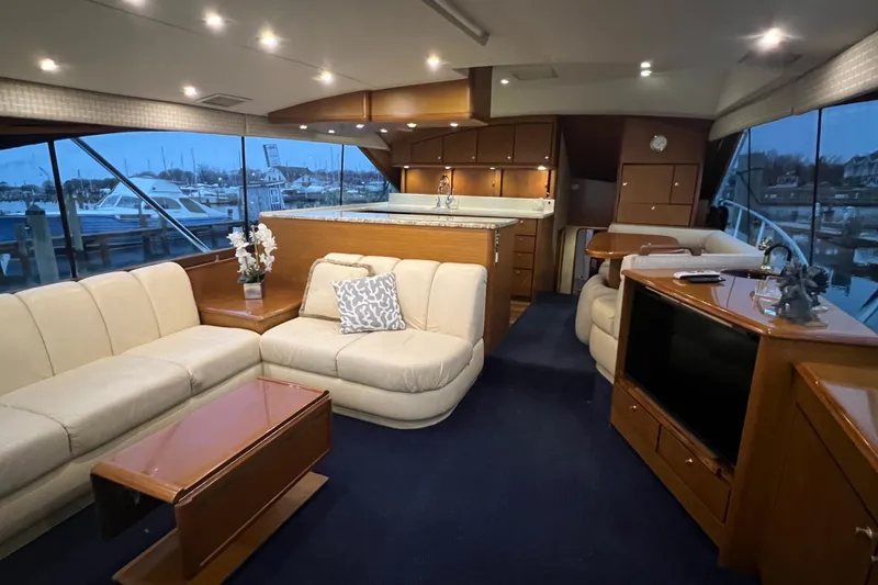 Slide: The Image of Luxurious interior of a 1999 Ocean Yachts 56 Super Sport with elegant furnishings and marina view. - 1