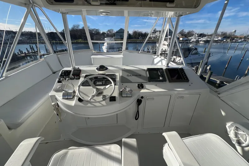 Slide: The Image of Cockpit of 1999 Ocean Yachts 56 Super Sport with navigation equipment and waterfront view. - 12