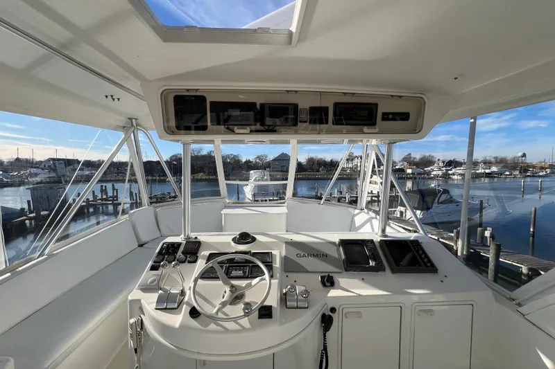 Slide: The Image of Cockpit view of 1999 Ocean Yachts 56 Super Sport with navigation equipment, docked at marina. - 13