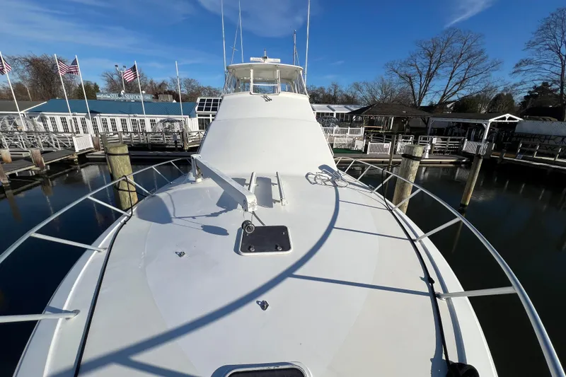 Slide: The Image of 1999 Ocean Yachts 56 Super Sport docked at marina under clear blue sky. - 20