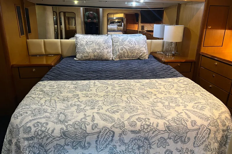 Slide: The Image of Luxurious bedroom interior of 1999 Ocean Yachts 56 Super Sport, featuring elegant bedding and wood cabinetry. - 23