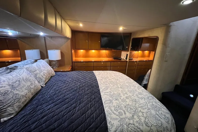 Slide: The Image of Luxurious bedroom in 1999 Ocean Yachts 56 Super Sport with elegant bedding and ambient lighting. - 24