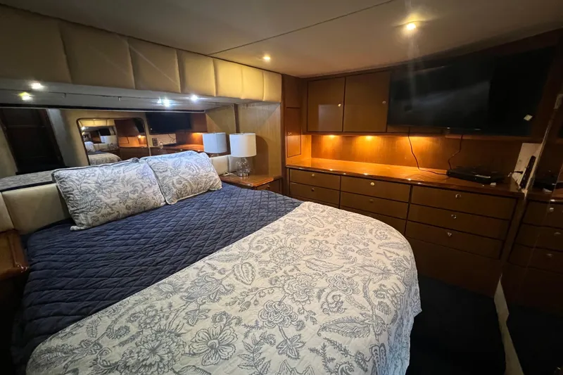 Slide: The Image of Luxurious bedroom interior of 1999 Ocean Yachts 56 Super Sport with elegant bedding and cabinetry. - 3