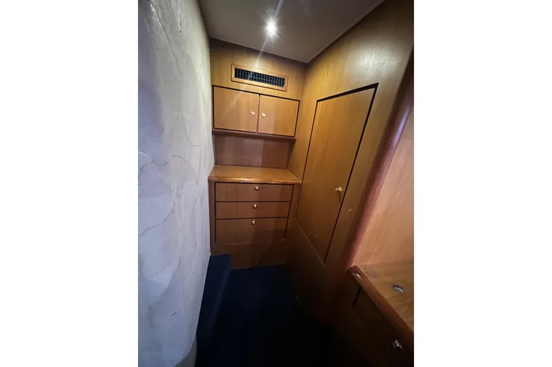 Slide: The Image of Wooden cabinetry in 1999 Ocean Yachts 56 Super Sport interior, featuring ample storage space. - 32
