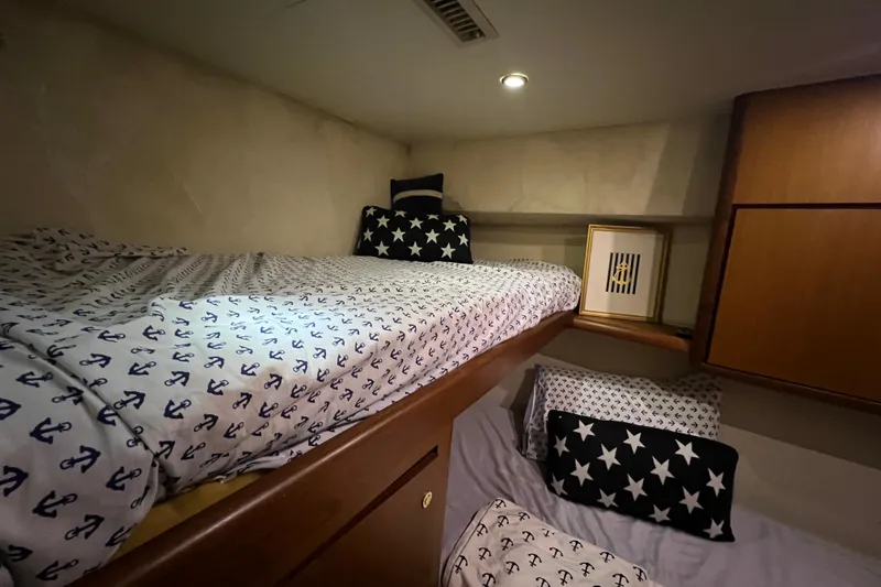 Slide: The Image of Cozy cabin interior of 1999 Ocean Yachts 56 Super Sport with nautical-themed bedding. - 33