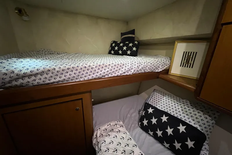 Slide: The Image of Bunk beds with nautical-themed bedding in 1999 Ocean Yachts 56 Super Sport cabin. - 36
