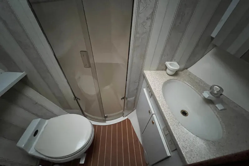 Slide: The Image of Bathroom interior of 1999 Ocean Yachts 56 Super Sport with shower, toilet, and sink. - 39