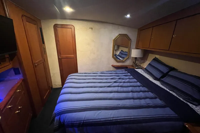 Slide: The Image of Luxurious bedroom interior of 1999 Ocean Yachts 56 Super Sport with striped bedding. - 43