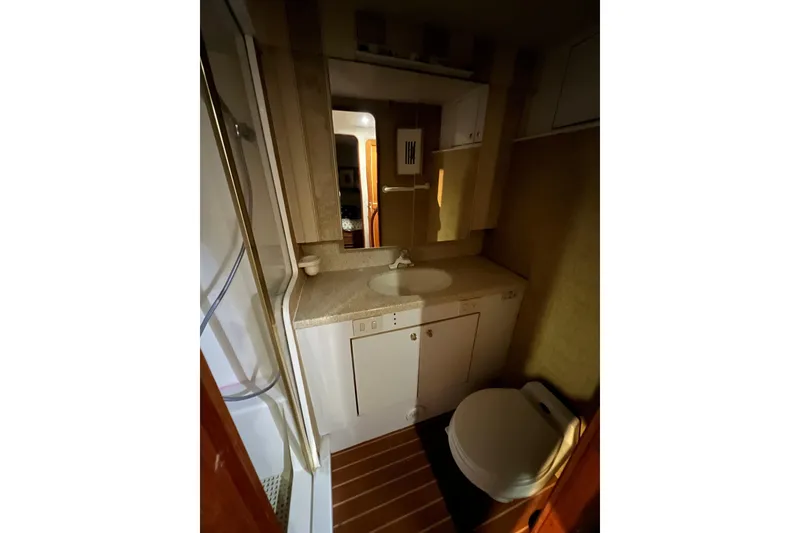 Slide: The Image of Bathroom interior of 1999 Ocean Yachts 56 Super Sport, featuring sink and toilet. - 47