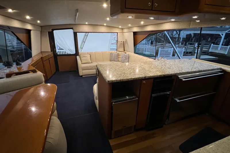 Slide: The Image of Luxurious interior of 1999 Ocean Yachts 56 Super Sport with elegant seating and modern kitchen. - 51