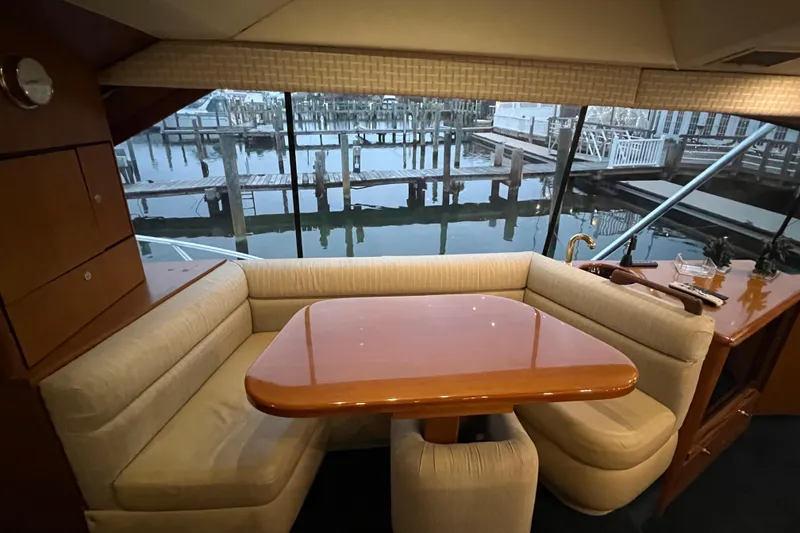 Slide: The Image of Interior of 1999 Ocean Yachts 56 Super Sport with dining area and marina view. - 54