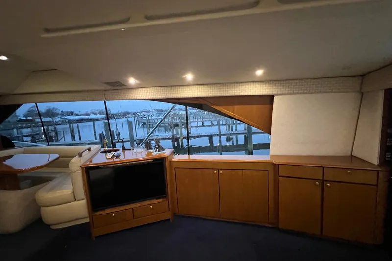 Slide: The Image of Interior of 1999 Ocean Yachts 56 Super Sport with waterfront view and wooden cabinetry. - 57