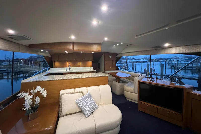 Slide: The Image of Luxurious interior of 1999 Ocean Yachts 56 Super Sport with elegant seating and panoramic windows. - 58