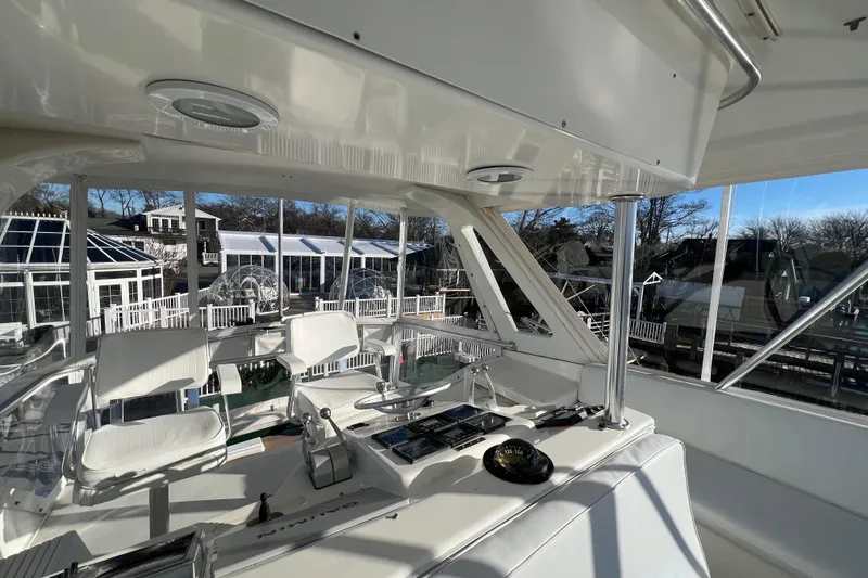 Slide: The Image of Interior view of 1999 Ocean Yachts 56 Super Sport, featuring helm and seating area. - 17