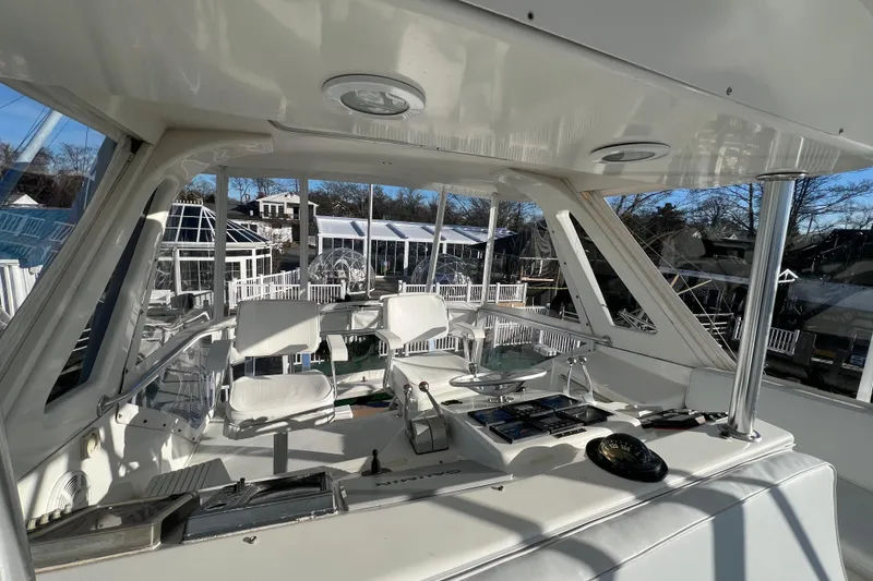 Slide: The Image of Interior view of 1999 Ocean Yachts 56 Super Sport cockpit with white seating and control panel. - 18