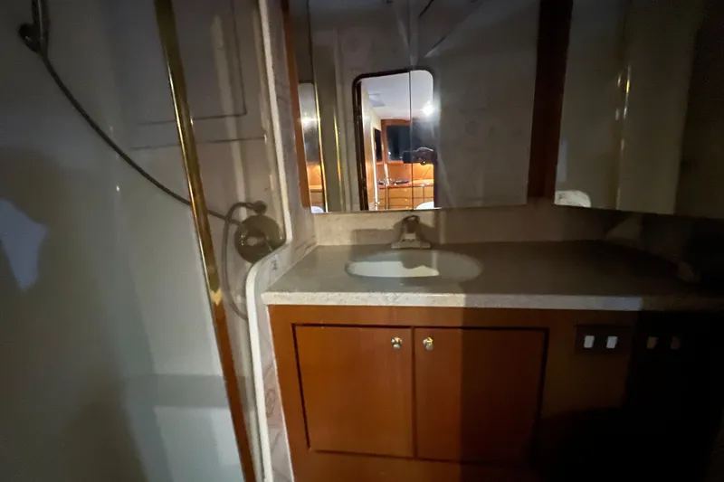 Slide: The Image of Bathroom interior of 1999 Ocean Yachts 56 Super Sport, featuring sink and shower. - 29