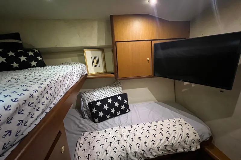 Slide: The Image of Cozy cabin interior of 1999 Ocean Yachts 56 Super Sport with nautical-themed bedding. - 34