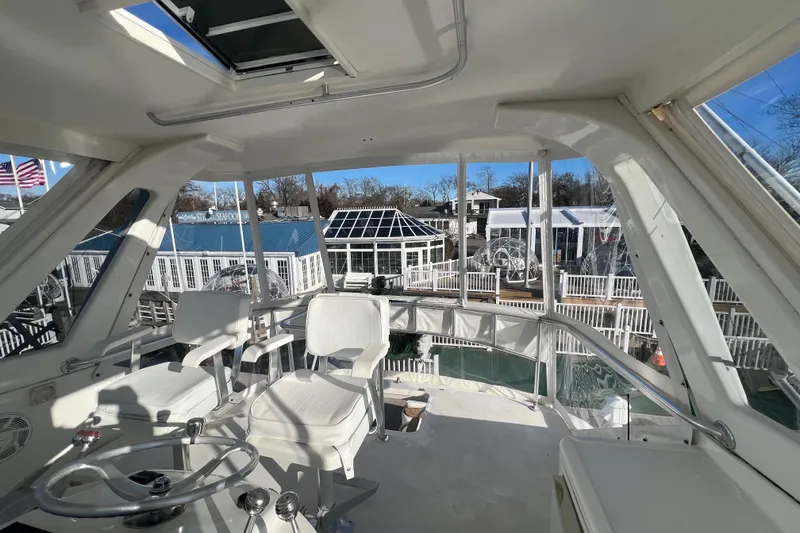 Slide: The Image of Interior view of 1999 Ocean Yachts 56 Super Sport, featuring helm and seating area. - 4